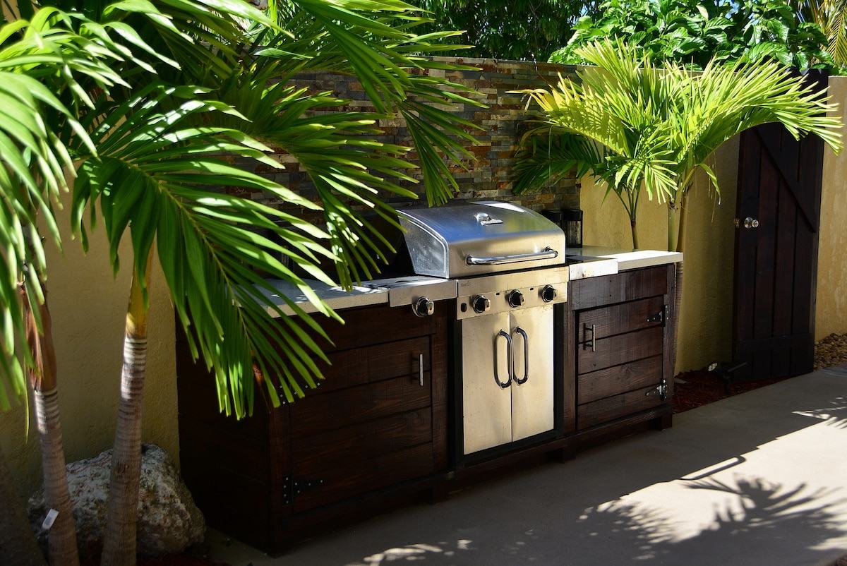 Built-in grill station among palms