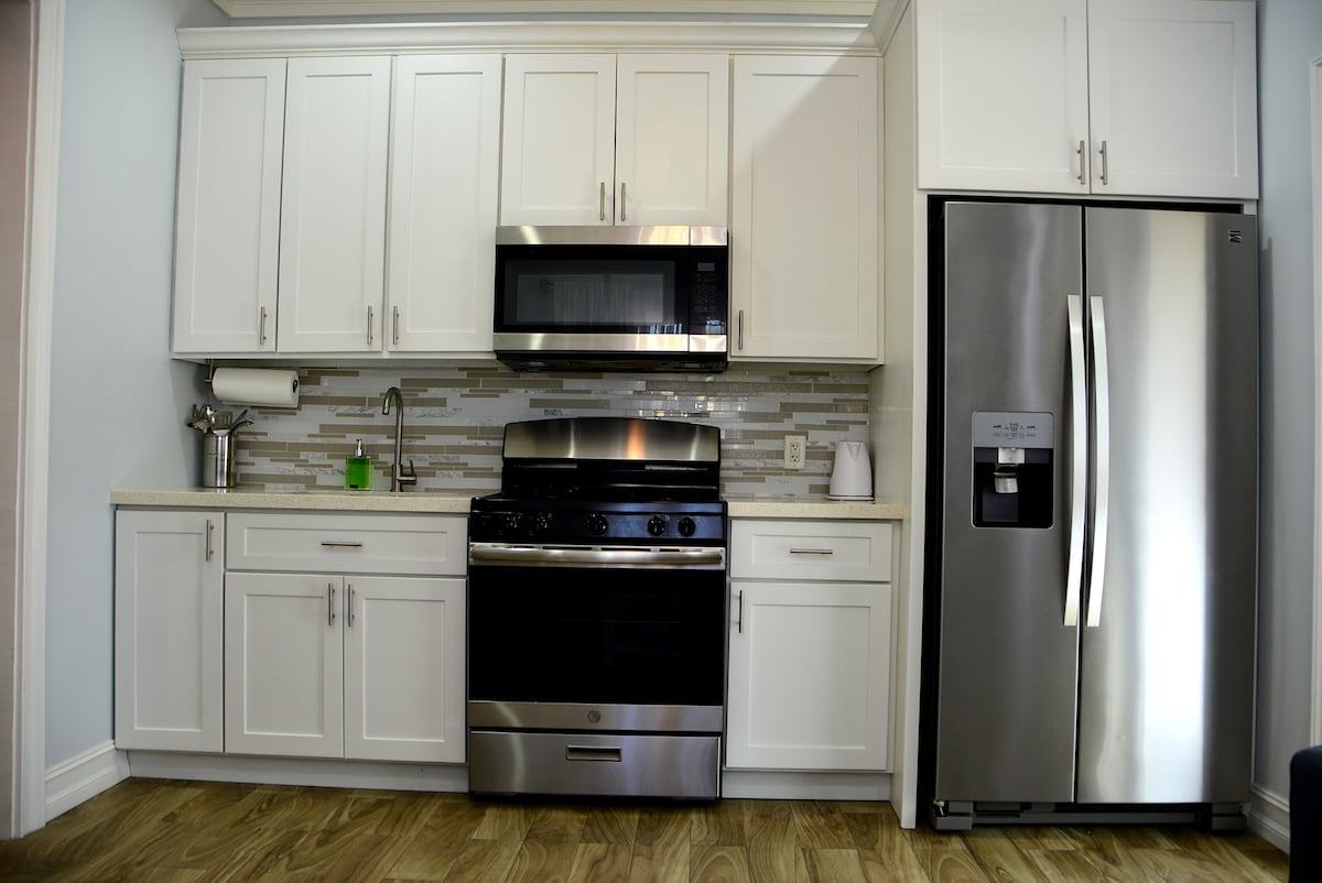 Kitchen with gas range, microwave and side-by-side fridge