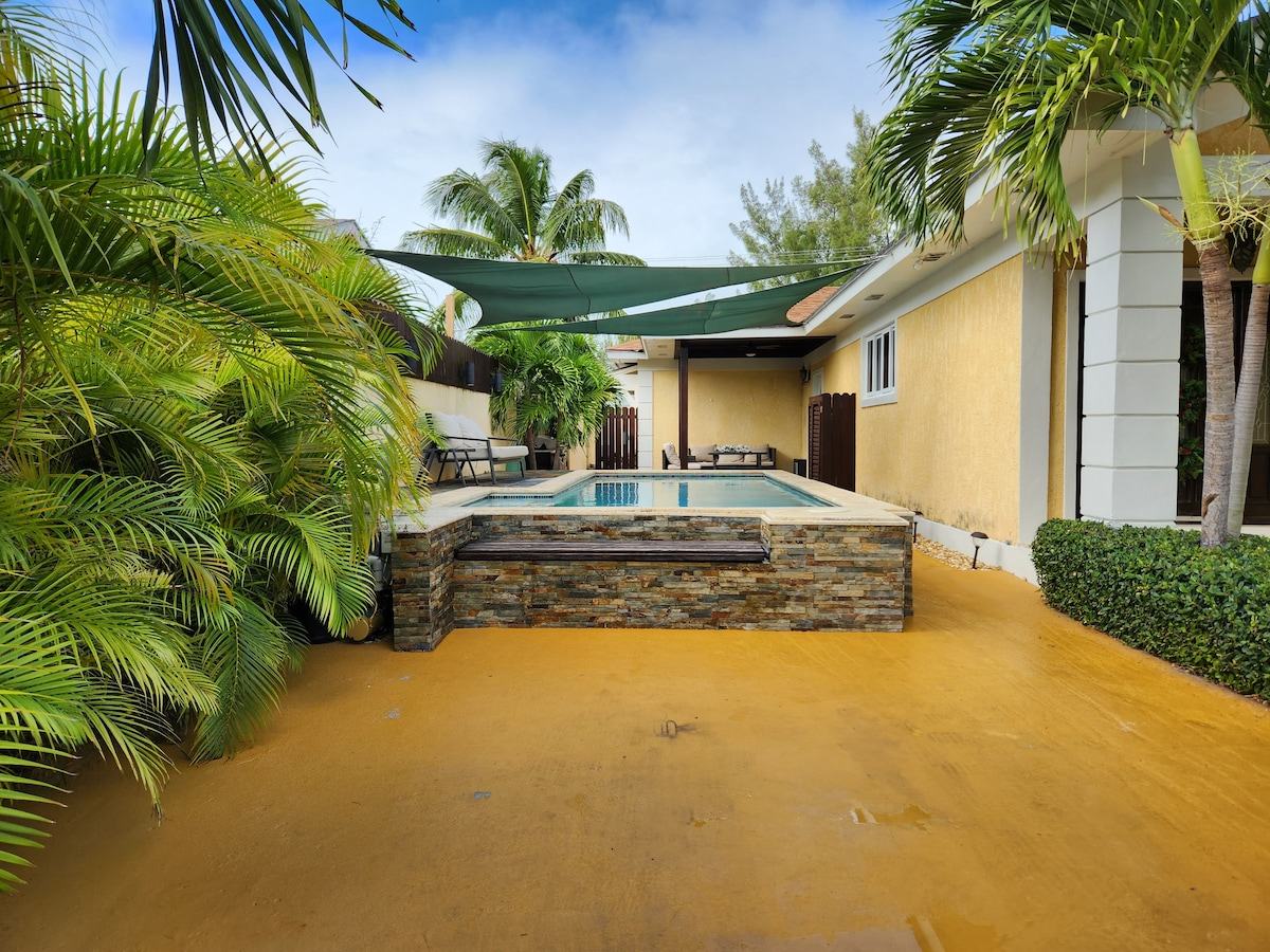 Courtyard and raised pool with shade sails